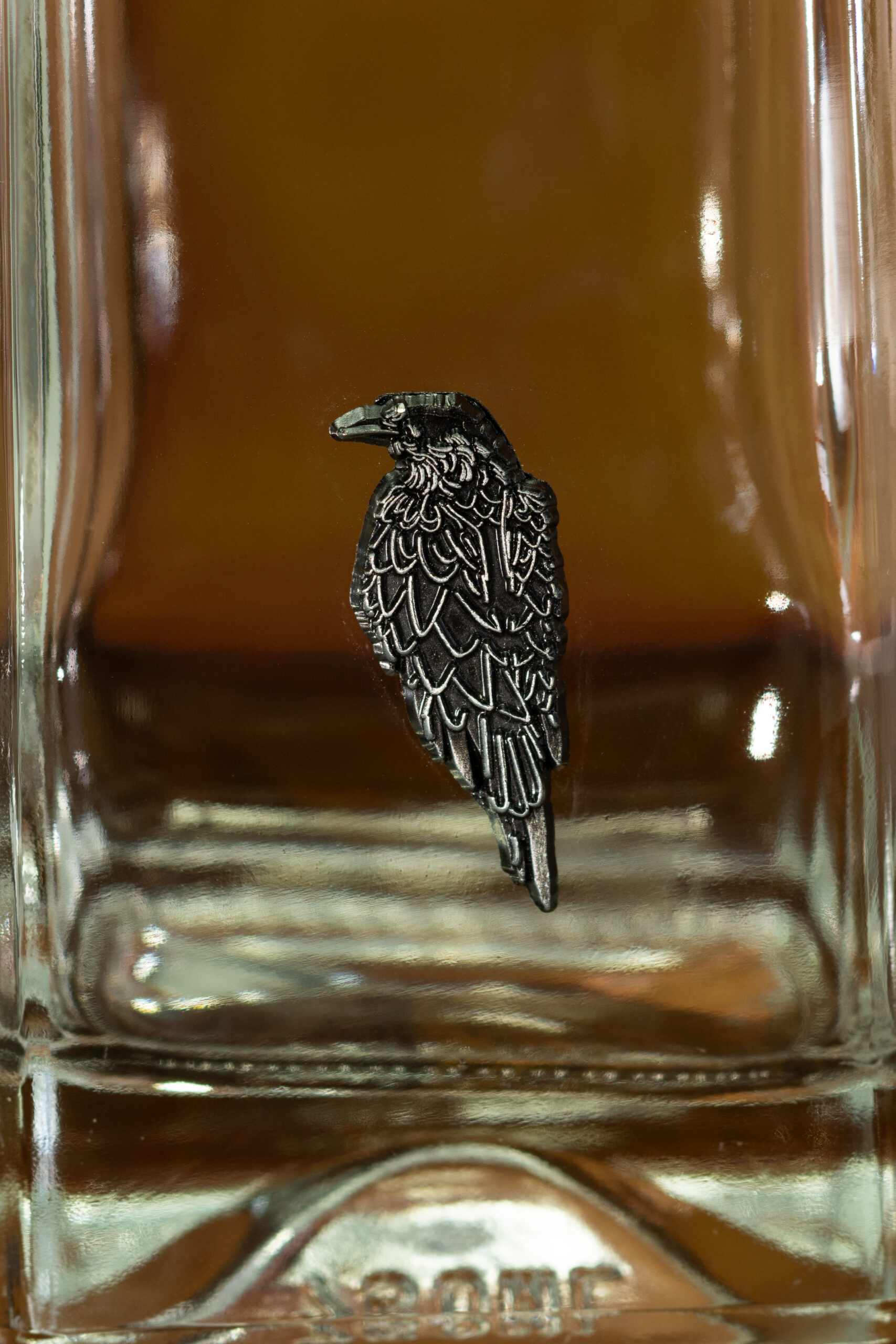 Metallic embellishment on a spirits bottle.