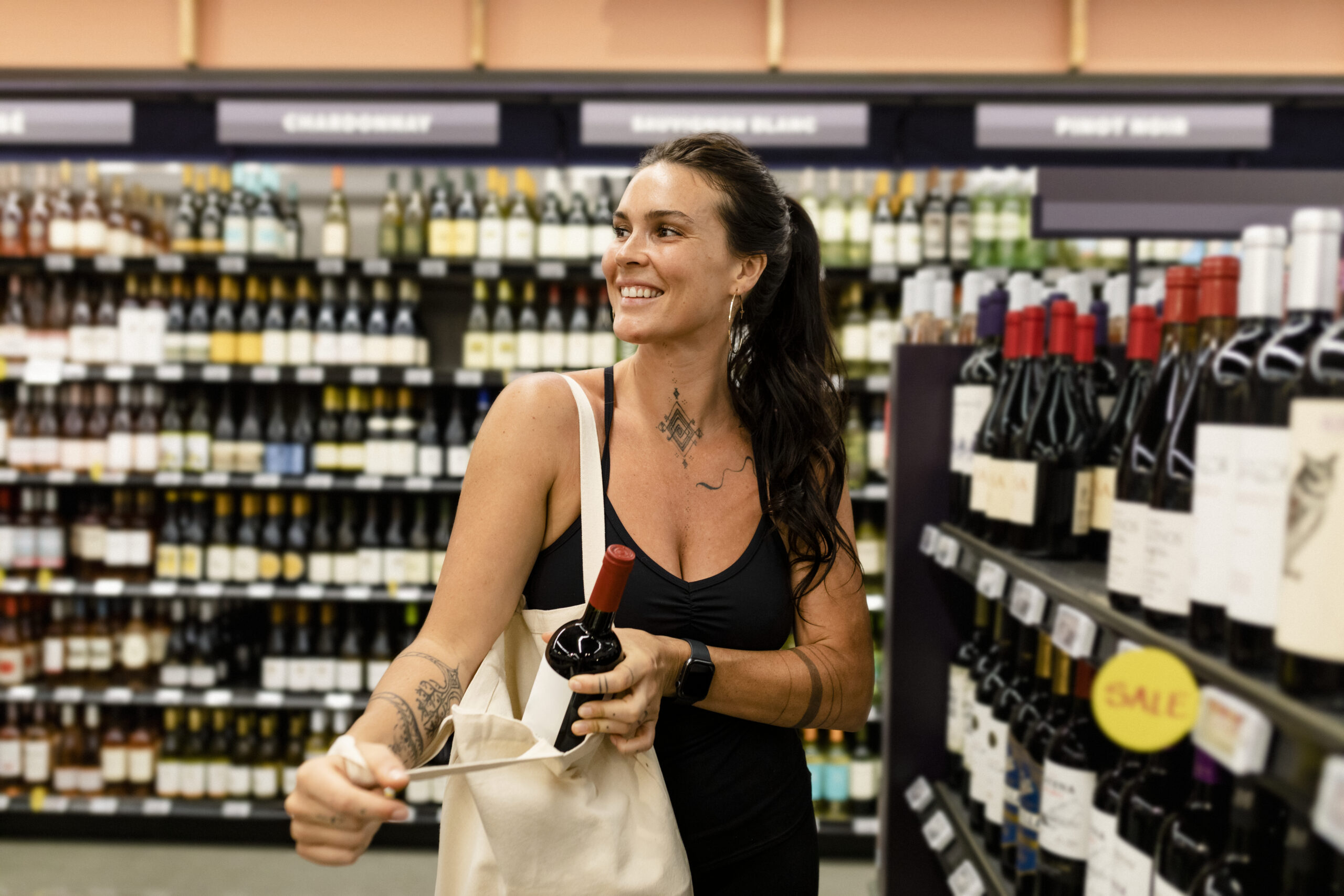 Woman buying wine, supermarket shopping HD image